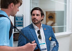 John Gavin '21 speaking with student at CSB Business Week