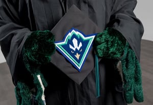 Sammy C. Hawk holding grad cap