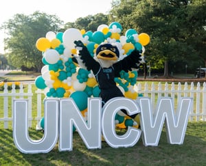 Sammy C. Hawk with balloons and UNCW lights